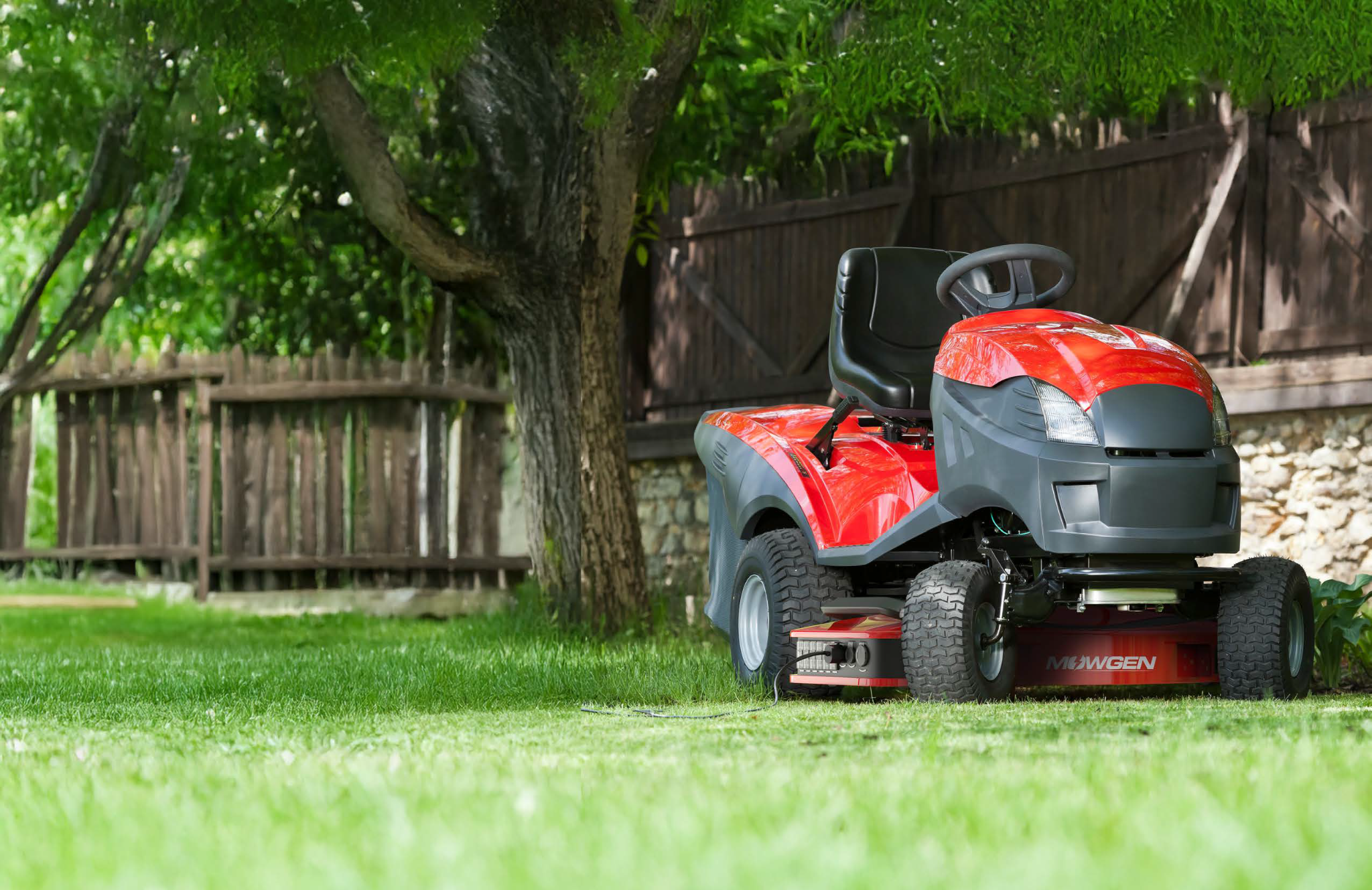 Red riding mower with the low-profile MowGen generator mounted beneath it